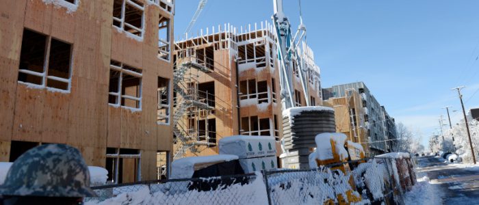 DENVER, CO - MARCH 24: Southern Land Company is developing this property in LoHi Denver at 18th and Central Streets. It will become a 302 unit apartment complex with retail space. They were at work on the space on Thursday, March 24, 2016 despite the recent snow. It is Southern Land's first project in Denver. Lead superintendent Joe Pluskota, lower left, walks along the outside of the project. (Photo by Cyrus McCrimmon/ The Denver Post)