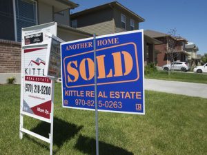 Sold Sign in front lawn of home in Fort Collins.