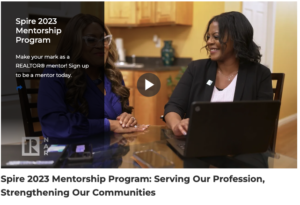 Women discussing mentorship program at a table.
